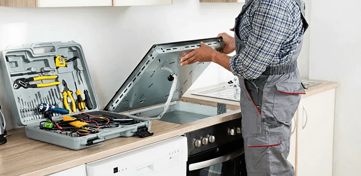 Handyman repairing a cooktop and checking wiring connections in Ogden, UT