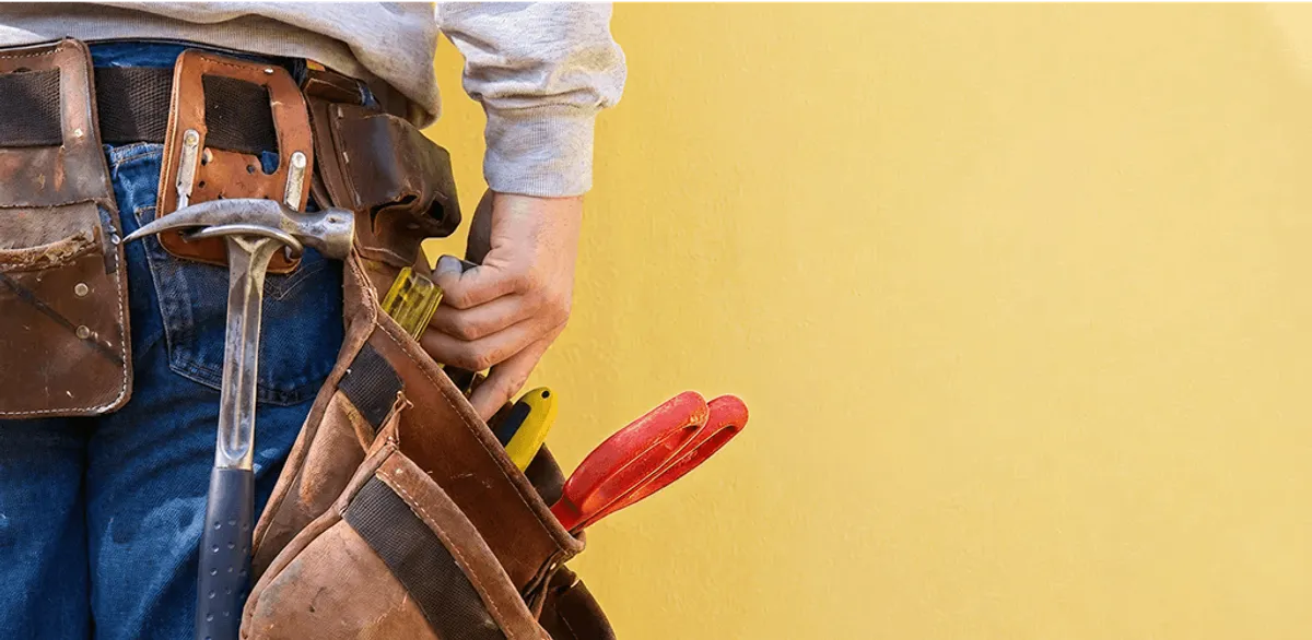 Handyman with tool belt ready for home repairs and maintenance in Ogden, UT